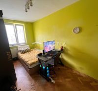 A room in a 3-room apartment with wooden decor and yellow walls.