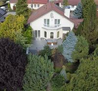 A family house in Trenčianske Stankovce surrounded by lush greenery and a garden.
