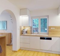 A kitchen in a family house with white cabinets, appliances, and a wooden decor floor.