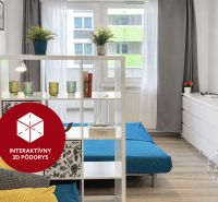 Living room with a white cabinet, decorative plants, and wood-patterned flooring.