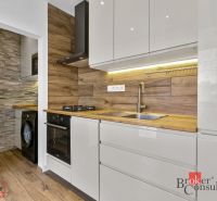 A kitchen with a wooden decor floor in a 5 or more room apartment, modern equipment.
