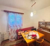 Dining room in a family house with furniture and decorations, wooden decor flooring.
