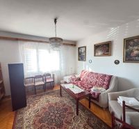 Living room in a family house with comfortable furniture and wooden decor flooring.