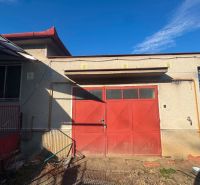 A family house in Dvory nad Žitavou with a red garage door on the street Dvory nad Žitavou.