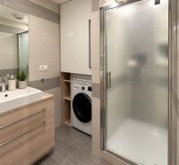 Bathroom in a 3-room apartment with a sink, shower, and washing machine.