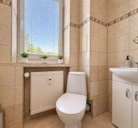 Bathroom in a 3-room apartment with ceramic tiles, toilet, and sink.
