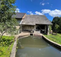 Family house in Mokrá Lúka with an ancient water reservoir and a green garden.