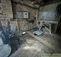 A rustic room in a family house with wooden and stone elements.