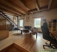 Interior of a family house with a wooden decor floor, stairs, and a wooden ceiling.