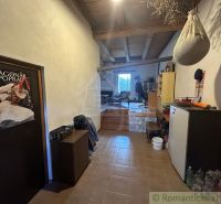 Interior of a family house with a beamed ceiling, furnished with furniture and decorations.
