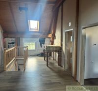 Attic in a family house with wooden beams and a wooden decor floor.
