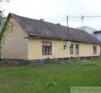 Yellow family house in Nemcovce with a grassy plot and a satellite dish.