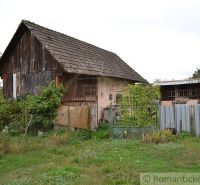A family house in Nemcovce with older wooden cladding and a garden.
