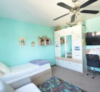 Children's room in a 3-room apartment with a wardrobe, desk, and bed.