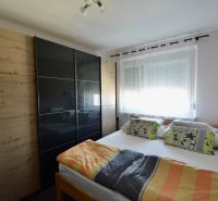 Bedroom with a double bed and a large wardrobe in a 3-room apartment.