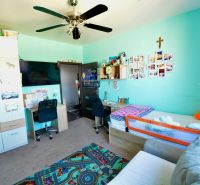 Children's room in a 3-room apartment with a soft carpet and furniture.