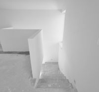 Concrete stairs leading to the lower floor in a family house.