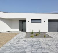 Family house on Kráľovianky in Šamorín with paving and a minimalist garden.