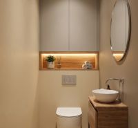 A bathroom in a 3-room apartment with modern equipment and elegant decorative lighting.
