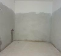 Uncounted room with plumbing preparation in a 3-room apartment.