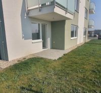 The exterior of a newly built 3-room apartment in Šámot, Šamorín with a terrace and lawn.