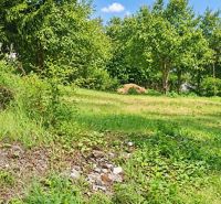 Green residential plots in Staškov surrounded by trees and grassy areas.