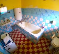 A bathroom in a family house with tiles and blue tiles.