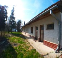 The exterior of a family house in Buková with a garden and trees on the property.