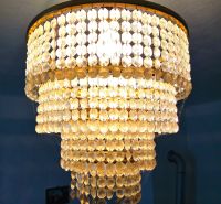 A crystal chandelier in the interior of a family house with soft lighting.