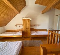 Interior of a holiday apartment with wooden furniture and a wooden decor floor.