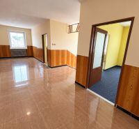 Interior of a family house with tiled flooring and wooden wall cladding.