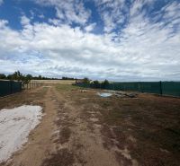 Building plot in Krušovce with a fence on the main street, ready for the construction of a family house.