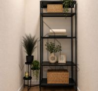 A shelf with decorations and plants on the floor with a wooden decor in a 3-room apartment.