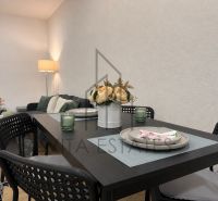 Dining area with floral decoration in a 3-room apartment, table and chairs.