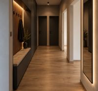 The hallway in a 3-room apartment with a wooden decor floor, black doors, and lighting.