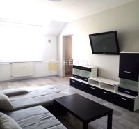 Living room with a sofa, TV, and wooden decor flooring in a 3-room apartment.