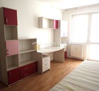 A bright room in a 3-room apartment with furniture and flooring in wood decor.