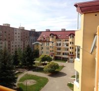 View from a 3-room apartment in Senica of residential buildings and greenery.