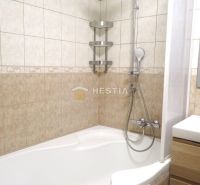 A bathroom with a shower and a bathtub in a 3-room apartment.