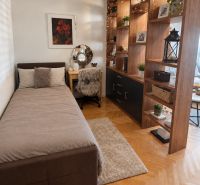 A bedroom in a 3-room apartment with a wood-decor floor and cozy furnishings.