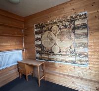 Wooden interior with a map, table, and shelves in a family house.