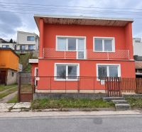 A family house on K. Sidora Street in Ružomberok with a red facade and a garden.
