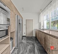 A modern kitchen with a marble floor and built-in appliances in a villa.