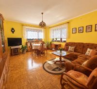 Living room of a family house with armchairs and a wooden decor floor.