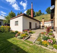 A family house in Liptovské Revúce with a beautiful garden, yards, and flower beds.