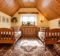 Wooden furniture in an attic bedroom with a view in a family house.