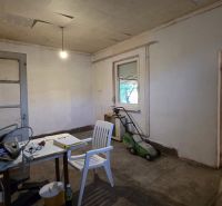 Interior of a family house with an unused room and basic furnishings.