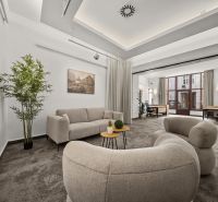 Offices with comfortable seating, desks, and a plant, ideal for productive work.