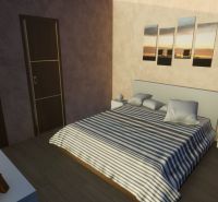 A bedroom in a family house with a striped bed and a wooden decor floor.