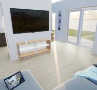 Living room in a family house with wood-patterned flooring and large windows.